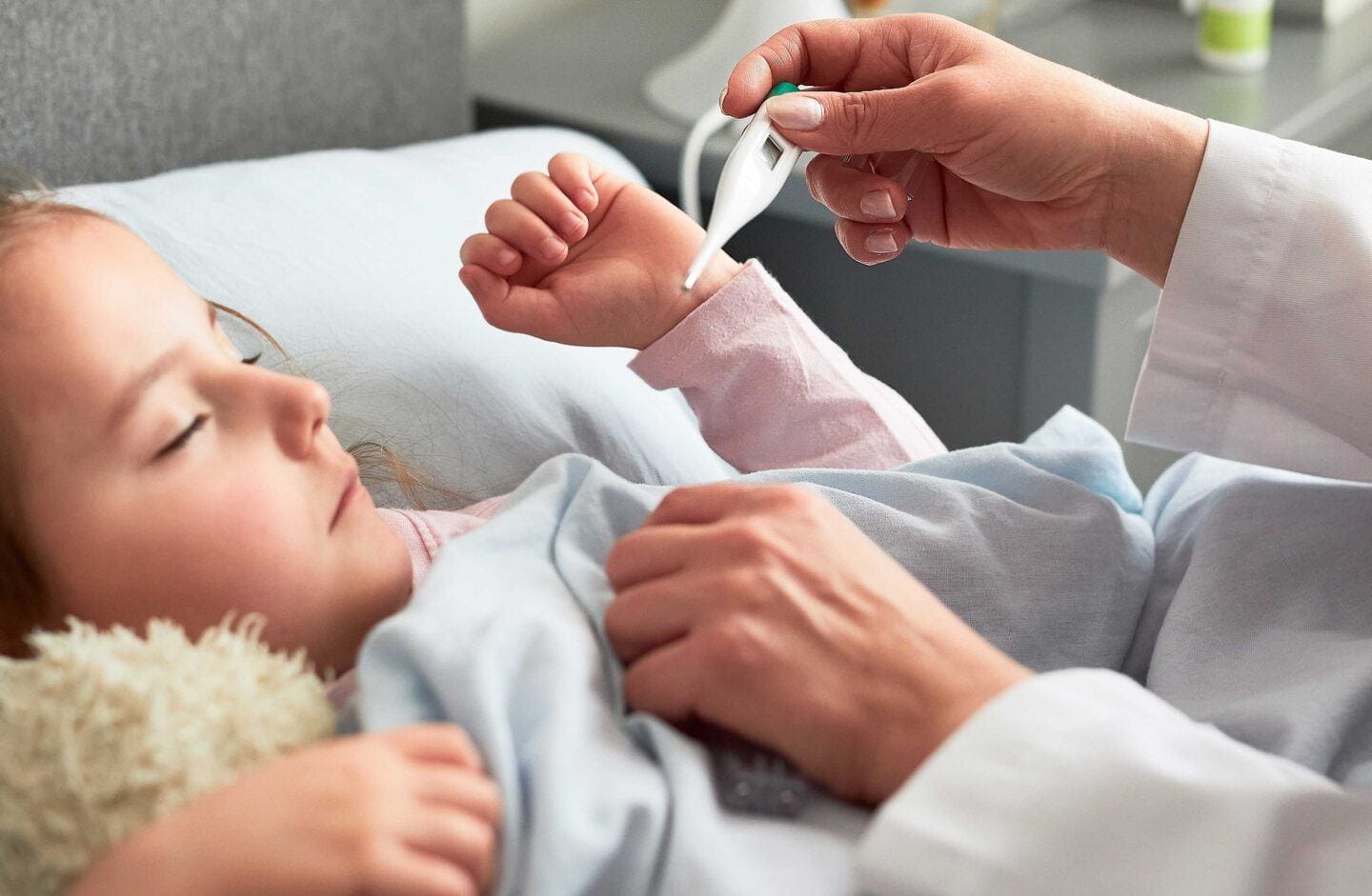 5 ways to help strengthen kids’ immune system this cold & flu season Doctor Visiting sick little girl and taking her temperature
