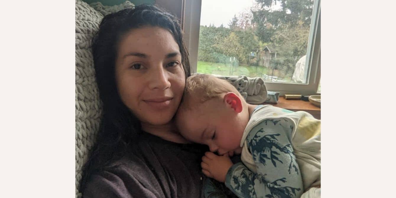 Leilani on postpartum depression after a traumatic birth experience mother taking selfie photo with sleeping toddler on her chest after healing from a traumatic birth experience