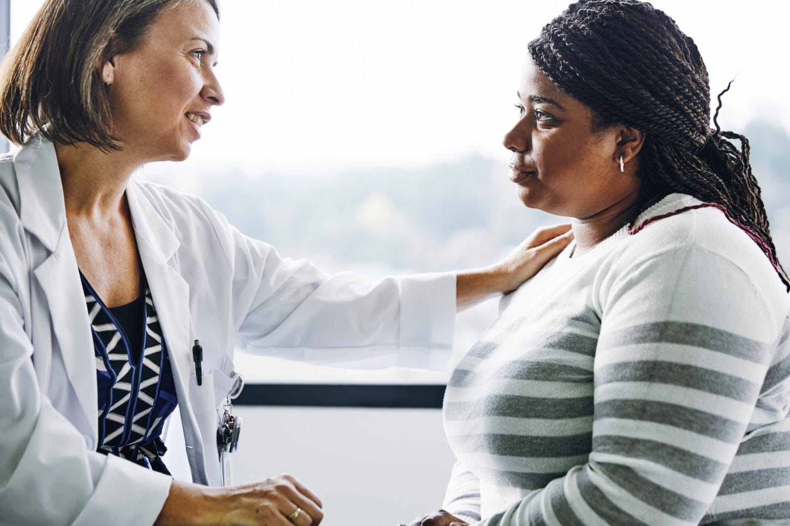 No, your OB/GYN should not be your primary care provider. Here’s why primary care: female doctor comforting female patient