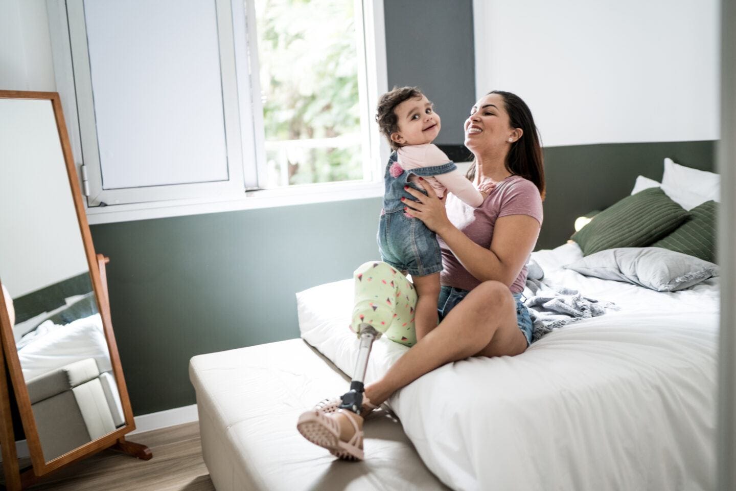Dear disabled mom: you’re doing a great job Disabled mom: Disability mother playing with baby girl at home