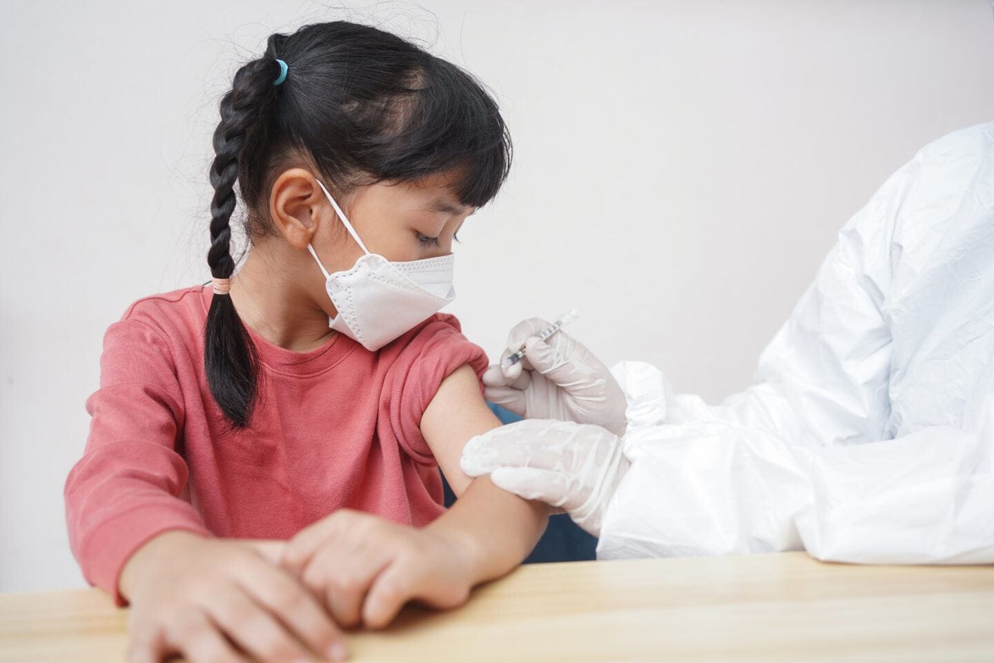 CDC recommends Pfizer Covid booster shots for children 5 to 11 years old pfizer covid vaccine kids 5-11: child receiving covid vaccine in upper arm