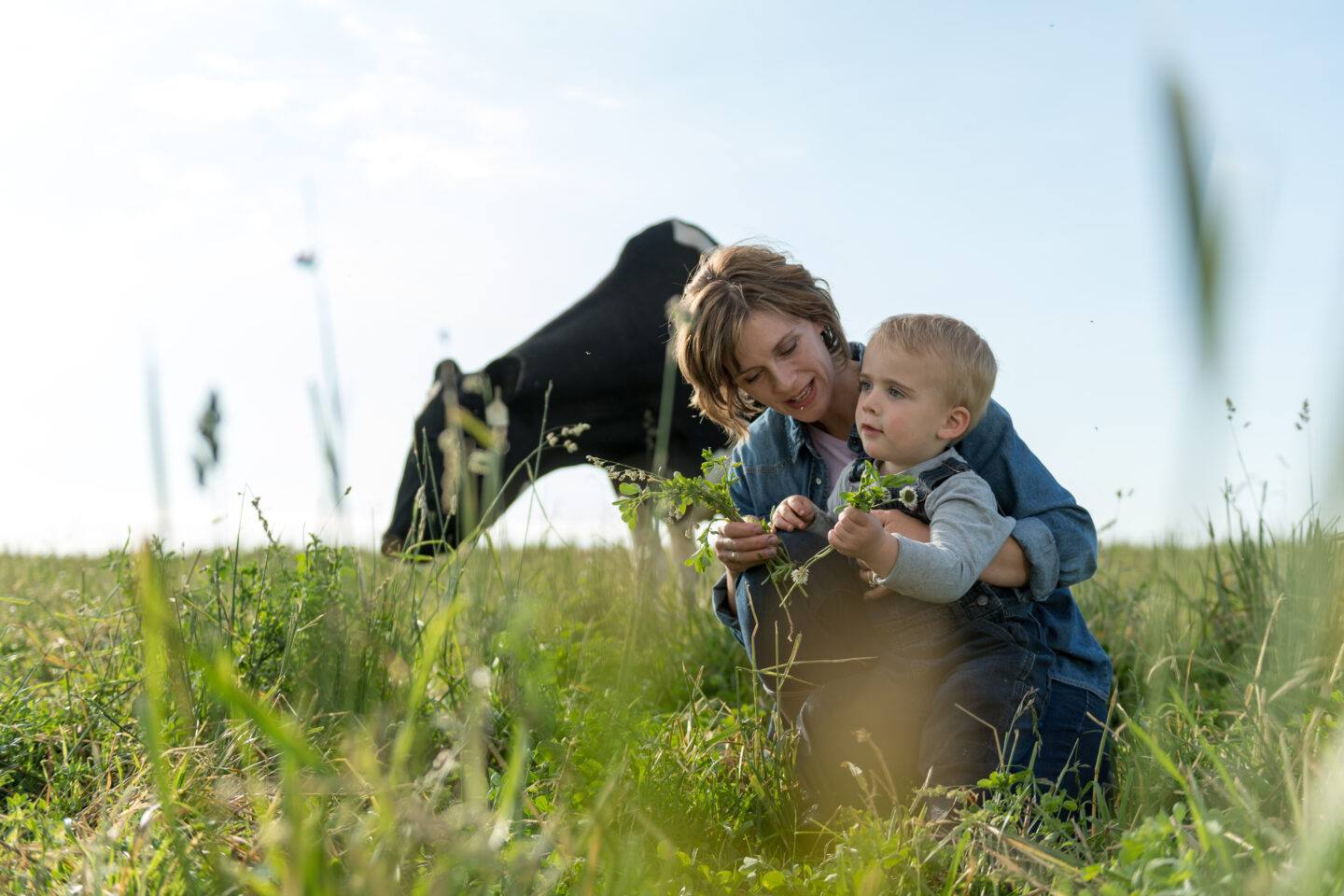 How to get the whole family excited about sustainable swaps mom and son in a field with a horse behind them