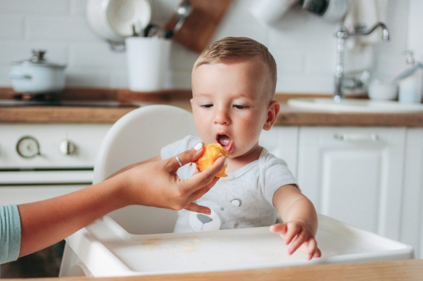 Once Upon a Farm baby food is the nutritious, delicious option my family needed mom feeding a little boy a pouch