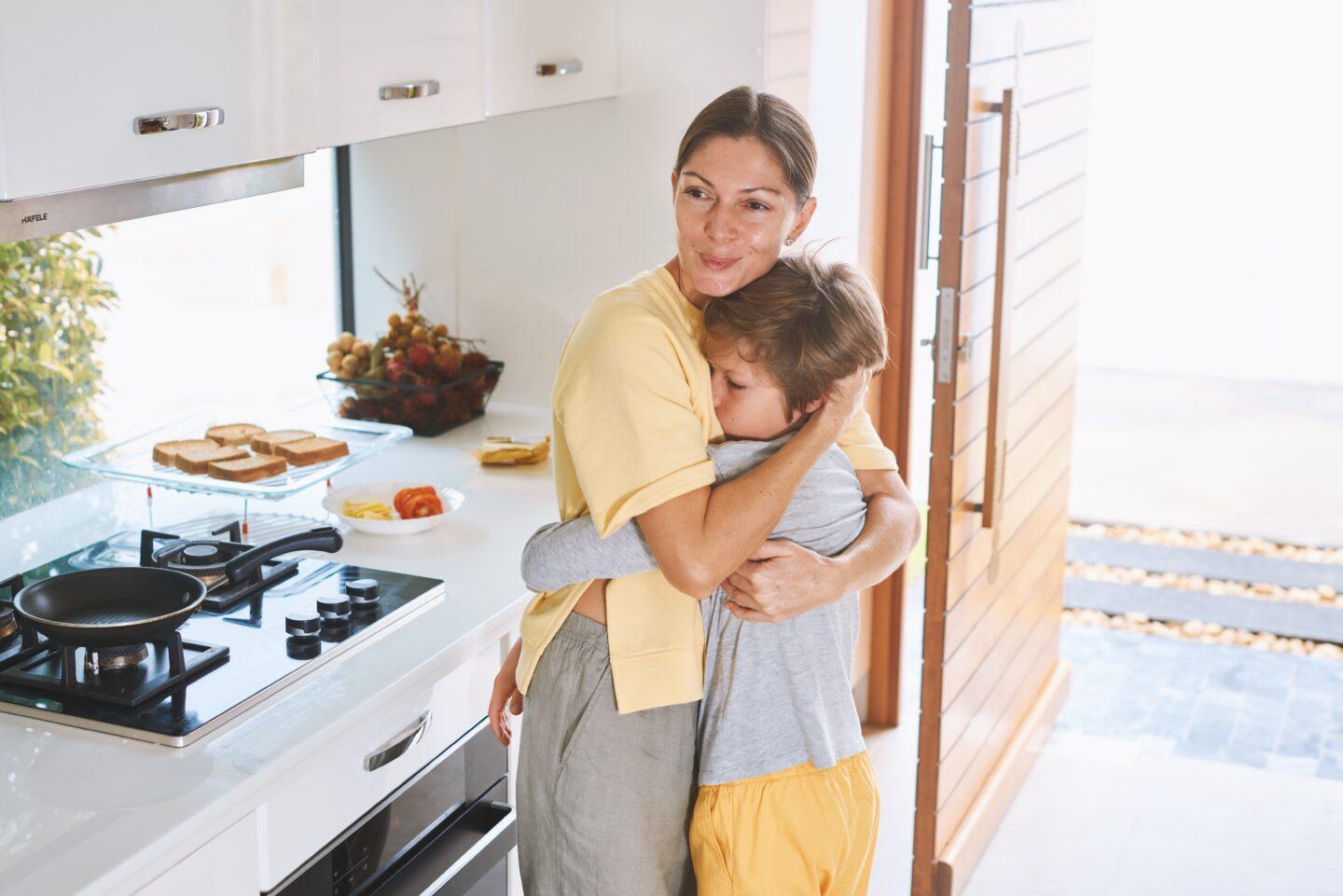 5 things to do when your child is diagnosed with obsessive compulsive disorder (OCD) ocd in children: mom and son hugging in kitchen at breakfast