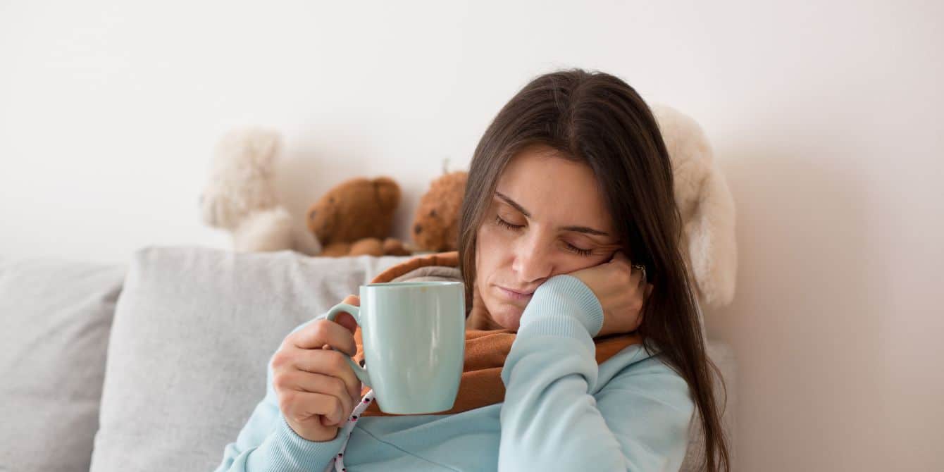 Unfortunately for parents everywhere, Daylight Saving Time remains a thing tired mom falling asleep while holding coffee cup- daylight saving time