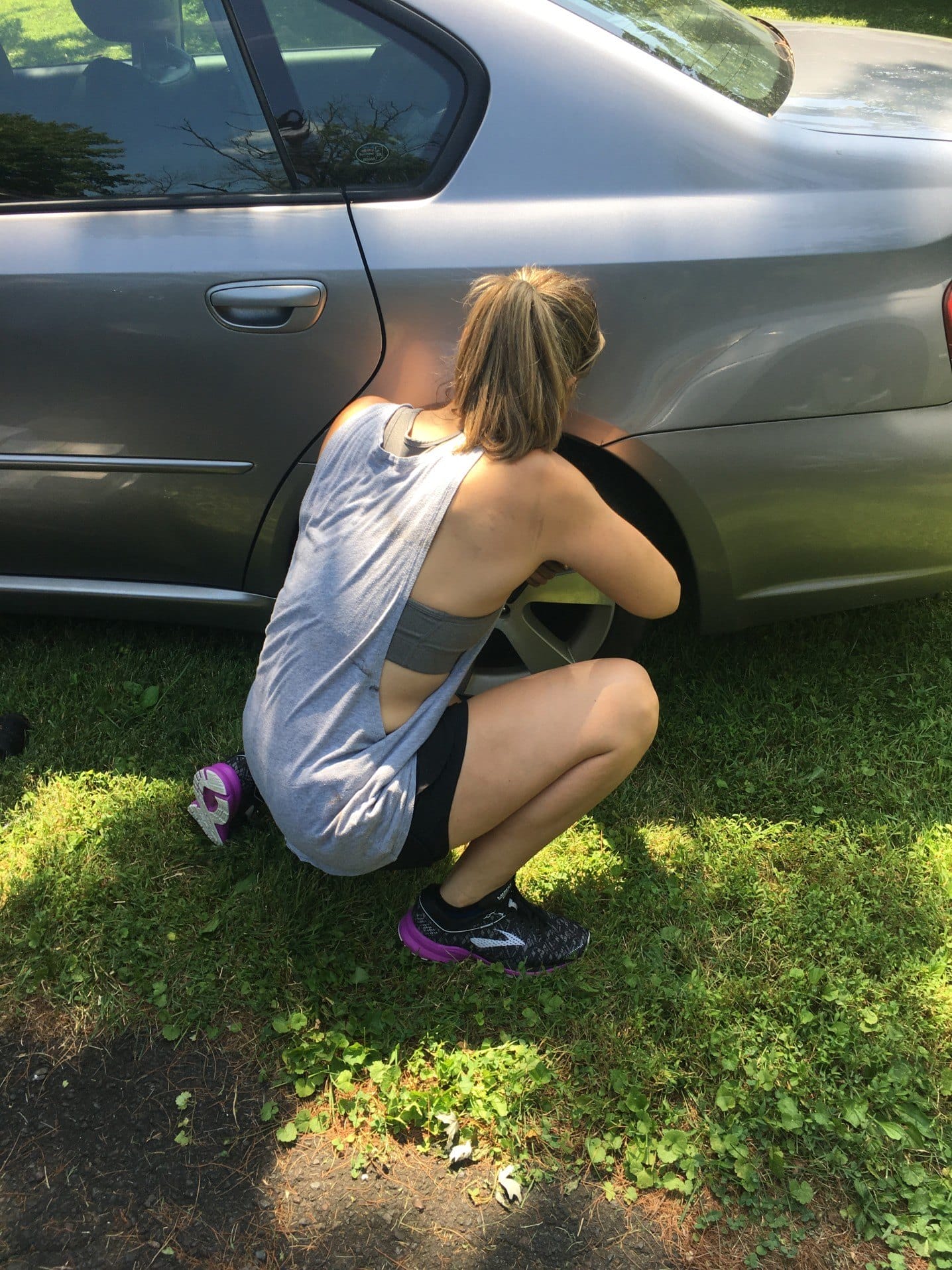 woman changing her tire professional woman independent millennial life working on car natural light t20 kR1yYR - Motherly