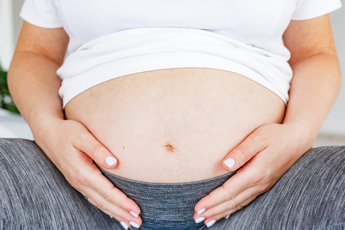 An overlooked tool in pregnancy and birth? Breathwork woman embracing her pregnant belly