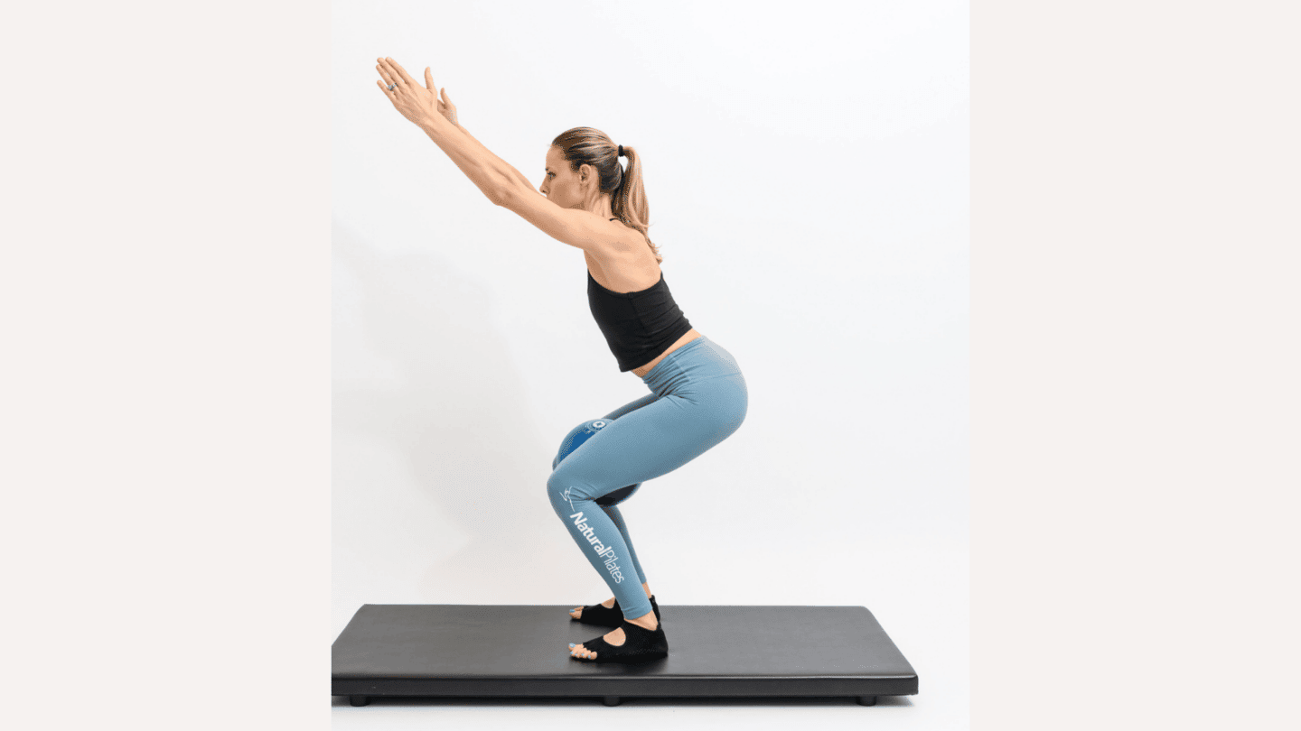 5 Pilates moves that are safe for postpartum postpartum pilates: woman doing squat pose