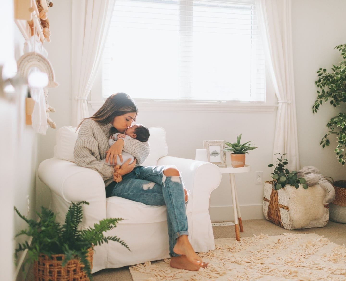 Packing away my baby’s clothes is necessary—but it breaks my heart  newborn clothing: mother kissing baby