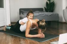 This is what moms get wrong about self-care, according to a therapist self care for moms: mother exercising at home with daughter - self-care for moms