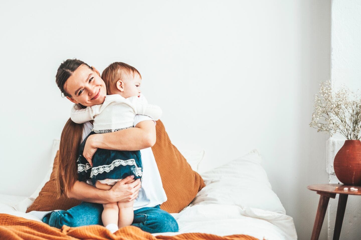 No, nothing happens to your eggs the day you turn 35 mother hugging baby sitting in bed - advanced maternal age
