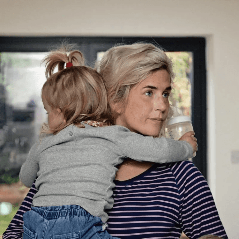This mama perfectly sums up what everyone gets wrong about maternity leave mom holding daughter on her shoulder