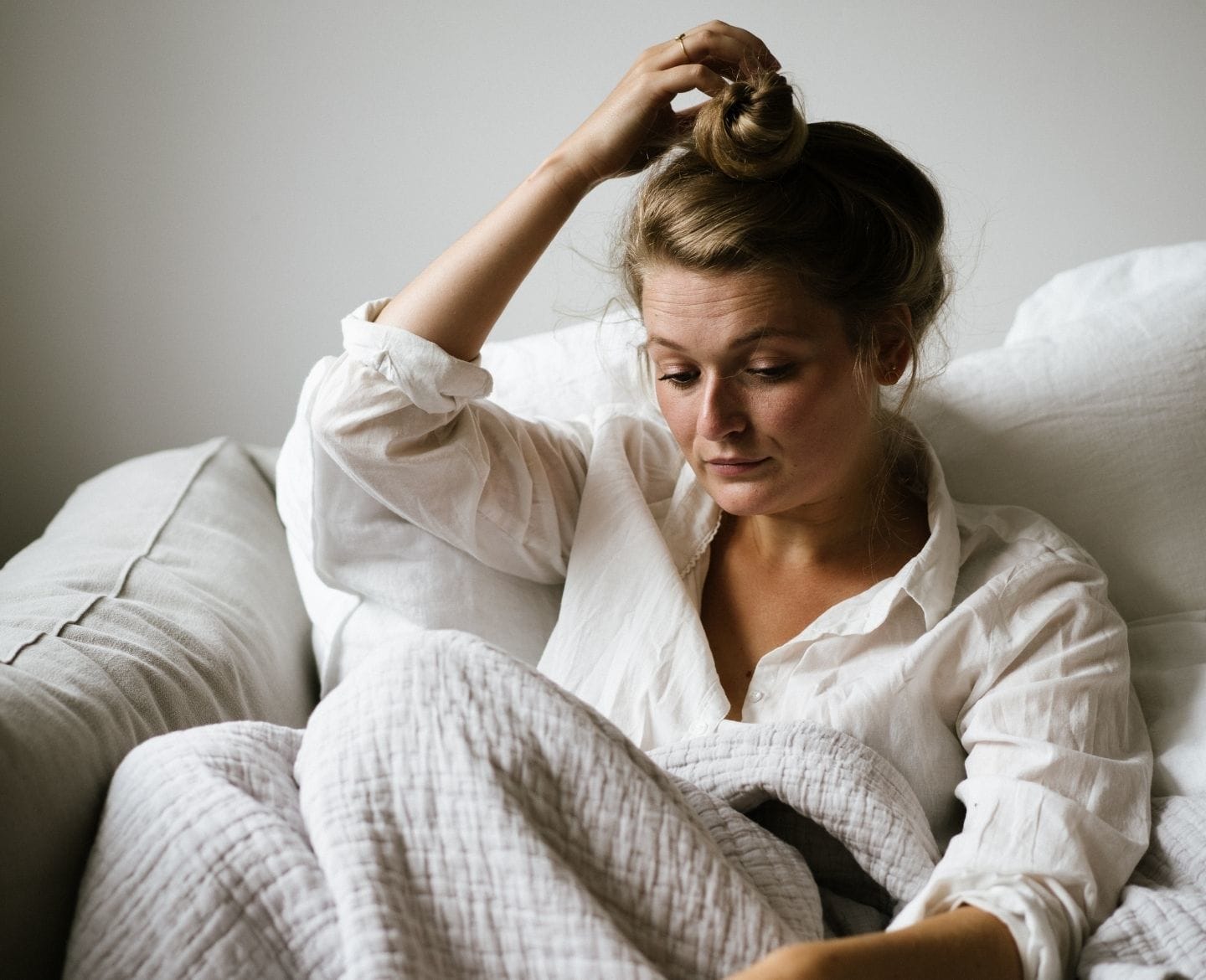Resources for safe abortion access and reproductive rights woman sitting on sofa looking down