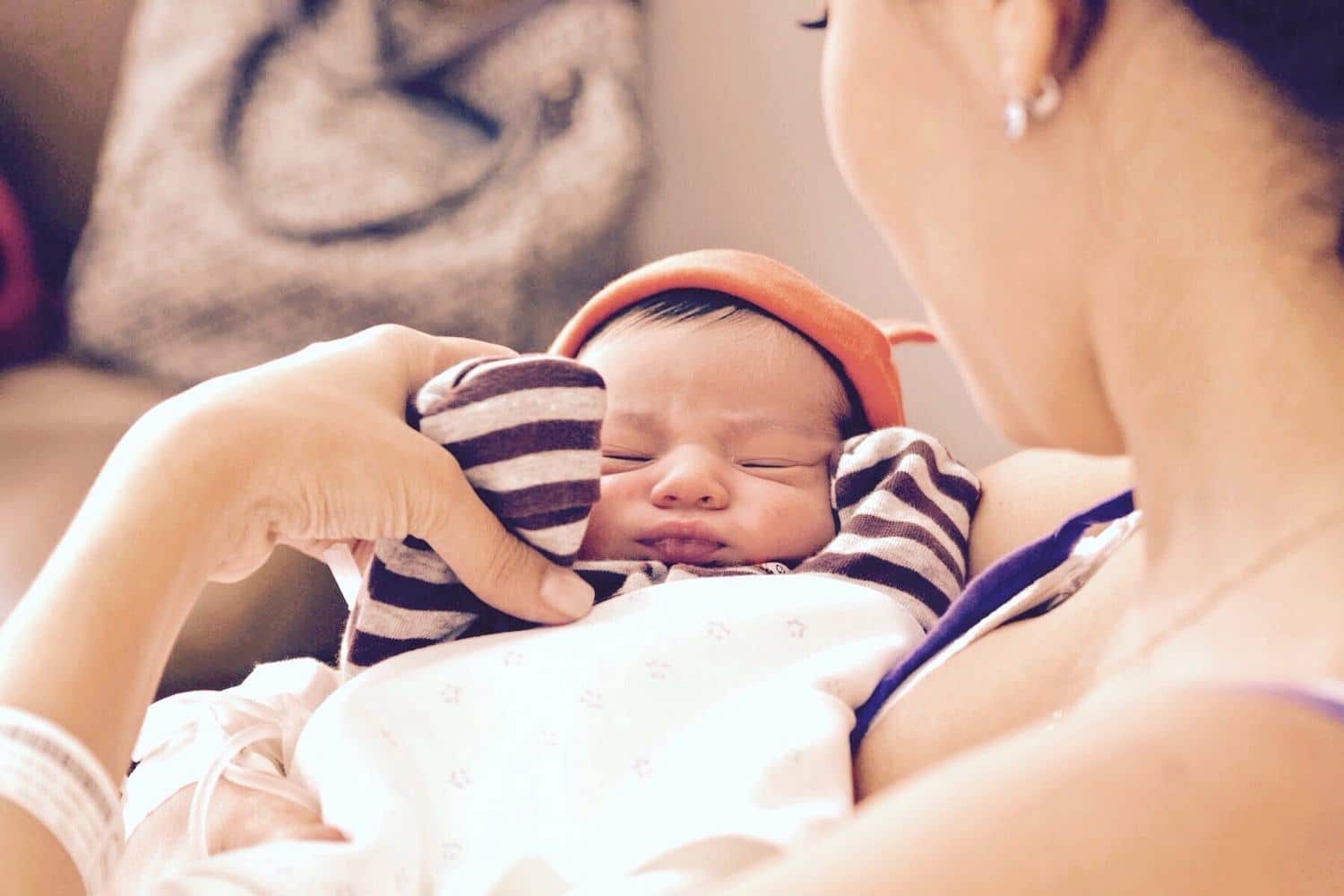mom holding newborn t20 e820l2 - Motherly