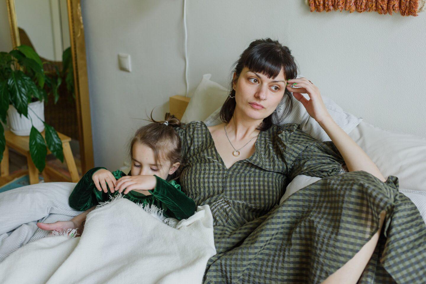 How to know when anxiety, depression and fatigue are symptoms of physical conditions tired mother in bed with daughter