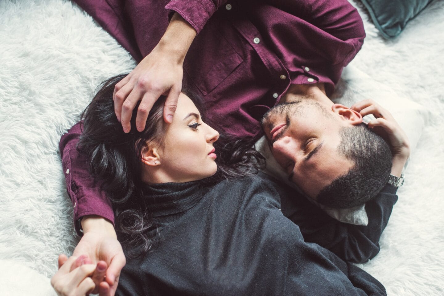 According to data, there’s a sweet spot for when your sex life returns after kids man and woman laying opposite of each other in a bed