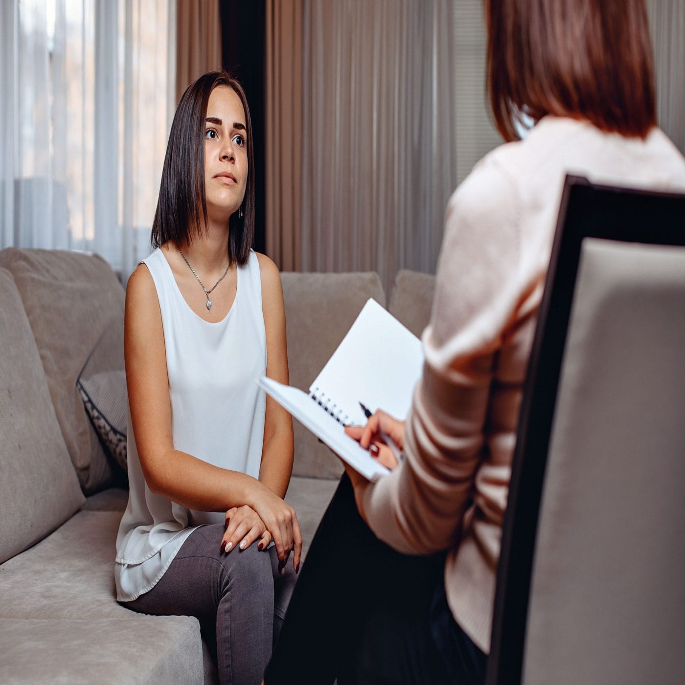 At my 6-week postpartum checkup, I lied to my doctor about my postpartum depression postpartum depression maternal mental health woman sits on couch in doctor's office