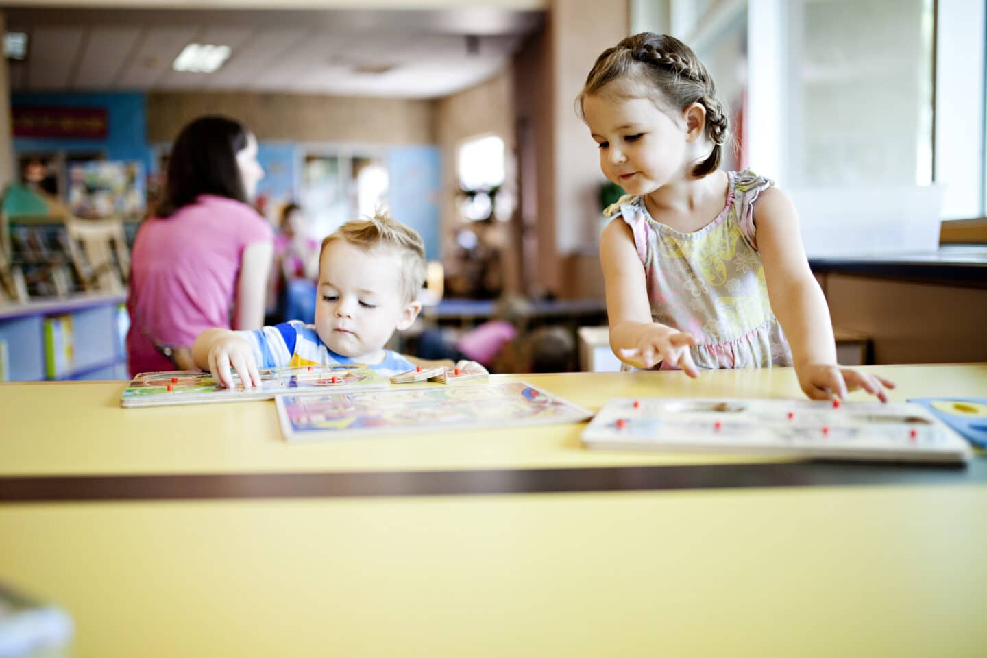 two kids working on puzzles at the library t20 pl1V18 - Motherly