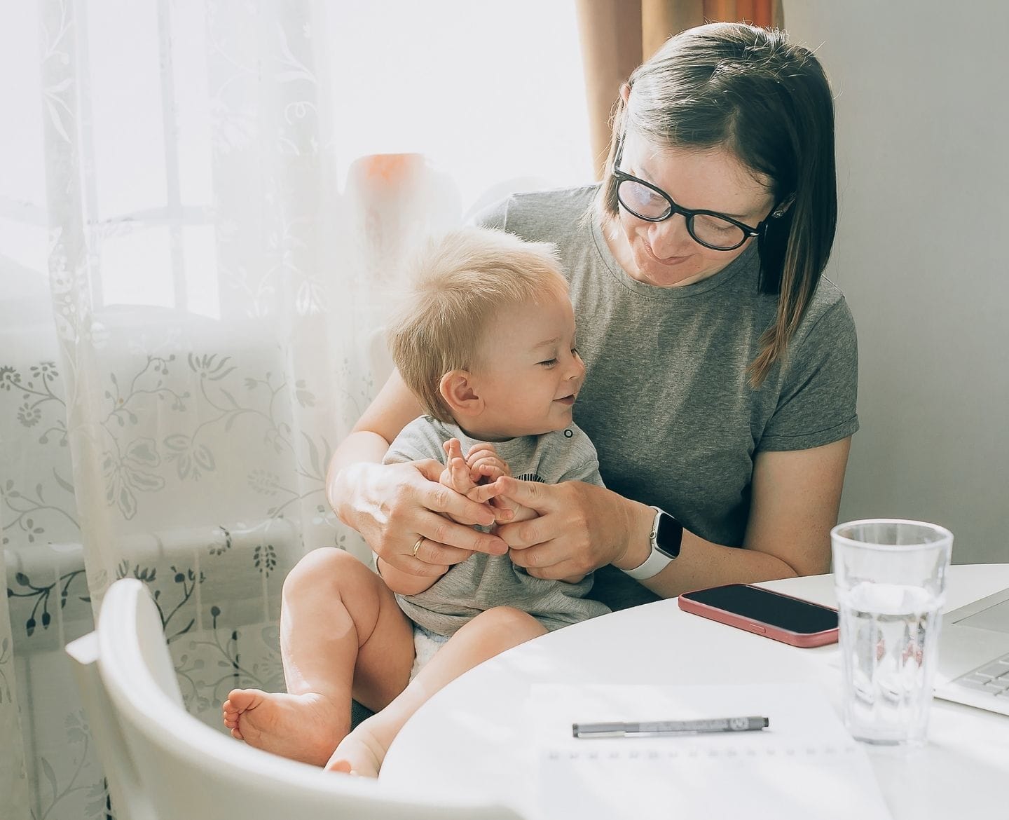Motherhood has been my greatest career asset mom and baby sitting at table