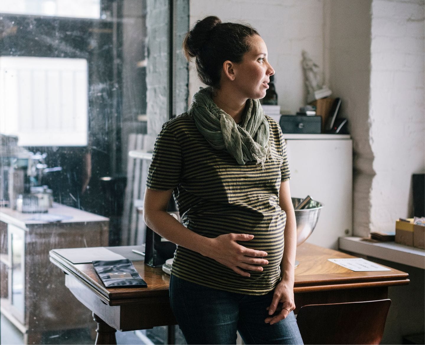Forced pregnancy impacts mental health. Here’s how pregnant woman at work looking away