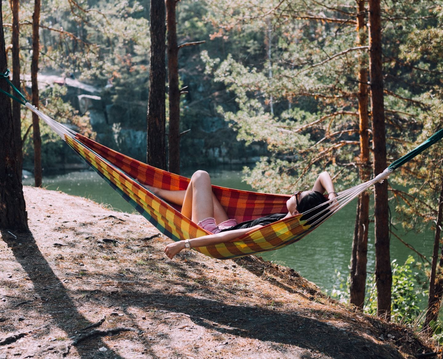 Summer is here—and so is my mom guilt woman laying in hammock