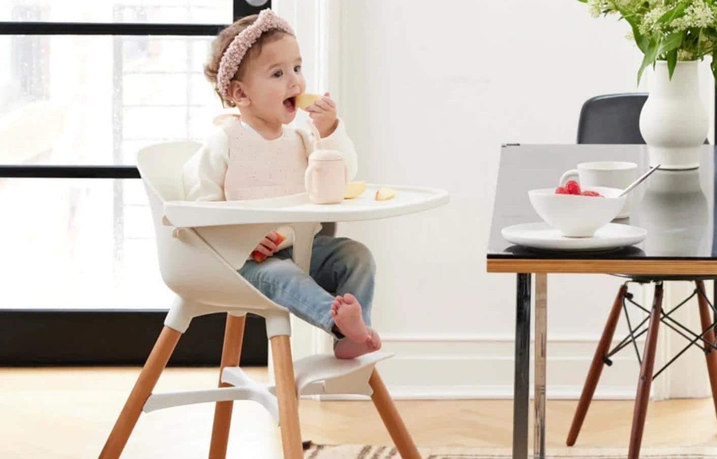 This high chair’s redesign was fueled by parent feedback–and it shows little girl in high chair