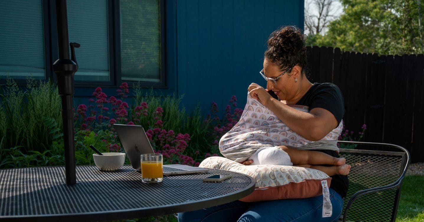9 products from Boppy to help you feel support as a new parent Woman breastfeeding a baby outside