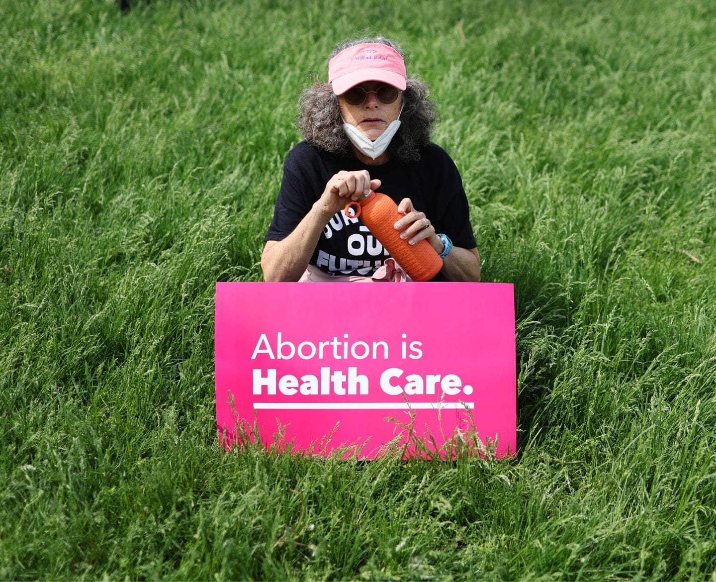 ACOG condemns Supreme Court decision overturning Roe v. Wade woman holding a sign that says 'abortion is health care' in abortion protest
