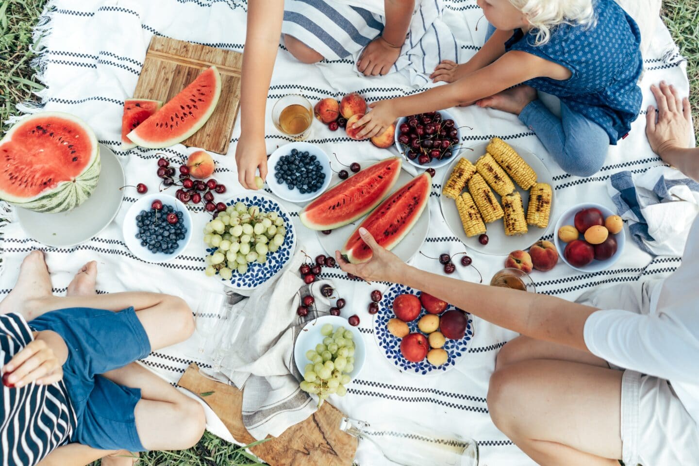 4th of July activities for kids who don’t like fireworks: Fun, safe & sensory-friendly ideas people eating a picnic on a blanket