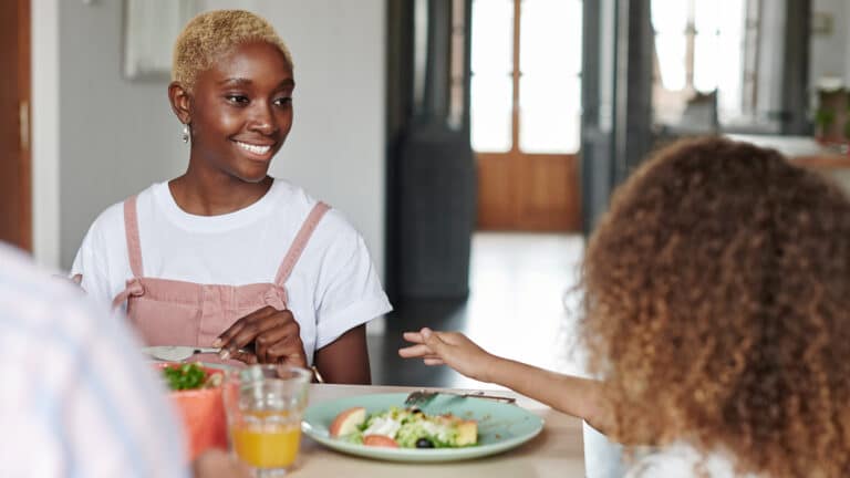 How improving your child’s gut health benefits their whole body mom and daugther at dinner 1 - Motherly