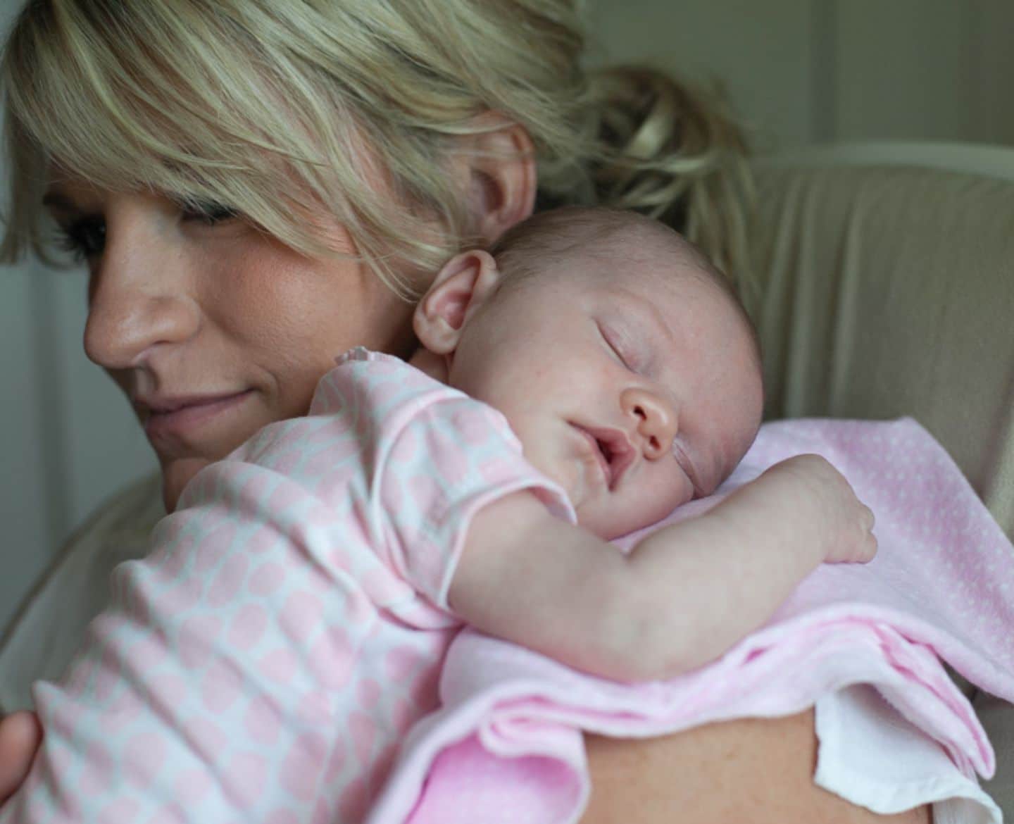 Let’s agree that new moms shouldn’t be expected to send thank you notes mom holding sleeping baby