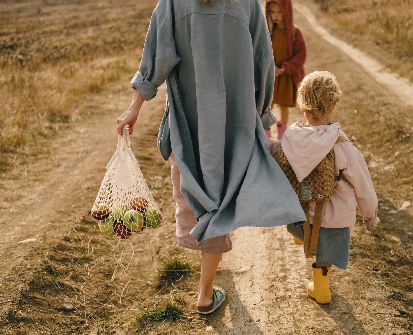 The majority of women who seek abortions are already mothers mother walking on dirt road with two children