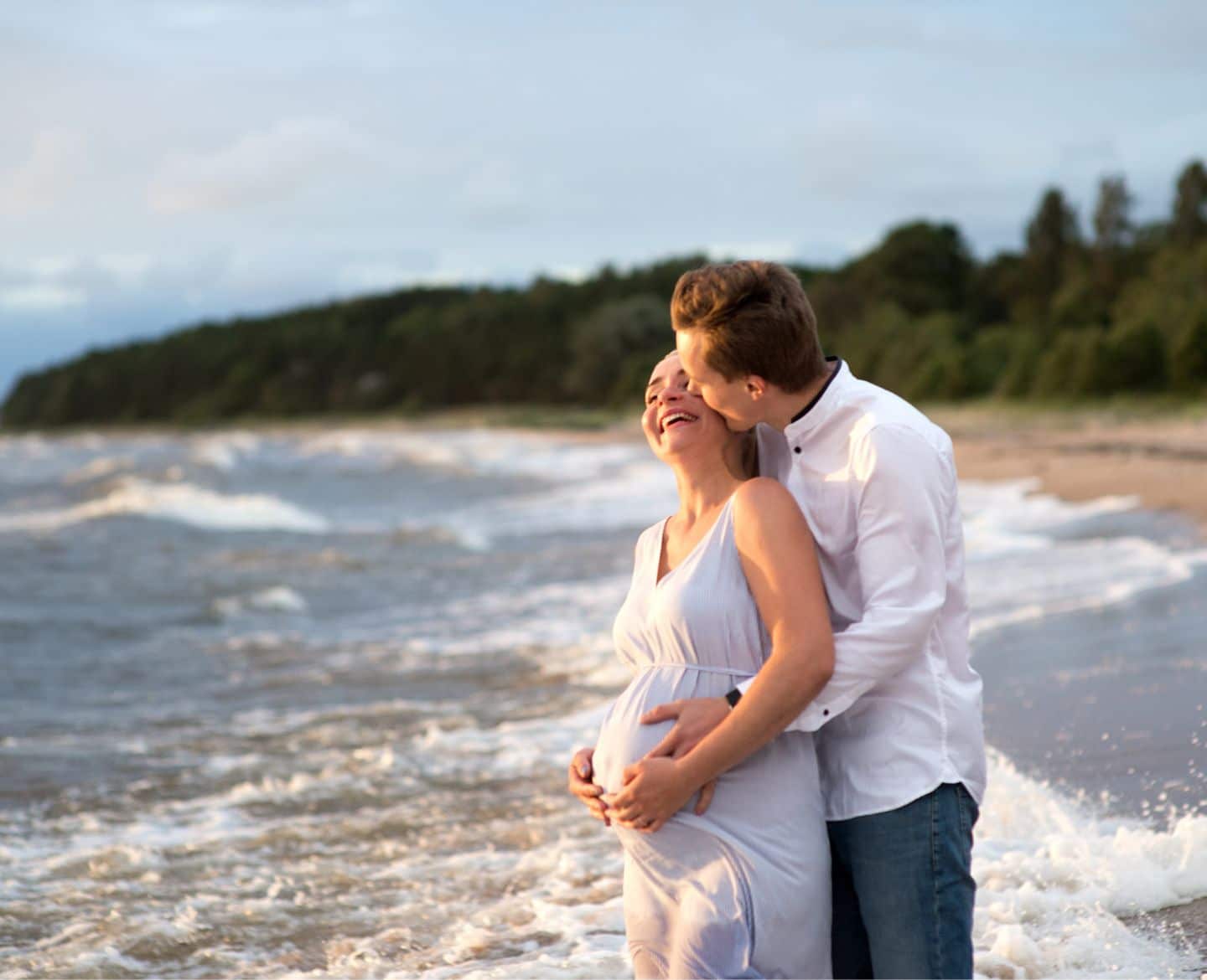 The 7 best babymoons, according to travel experts pregnant woman & partner on beach - babymoon destinations