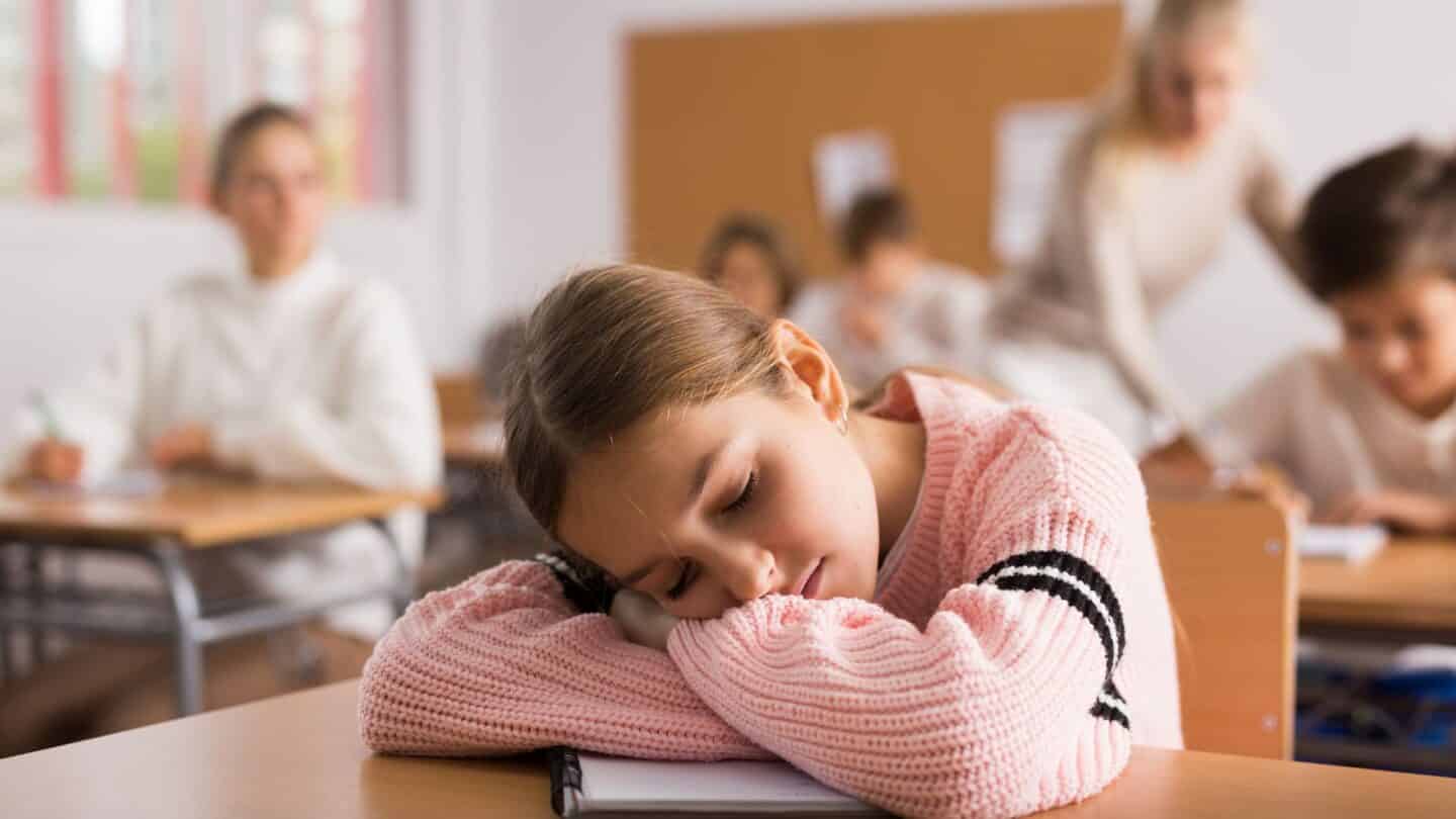 California becomes first state to delay school start times—here’s why that matters Girl asleep in school due to early school start time
