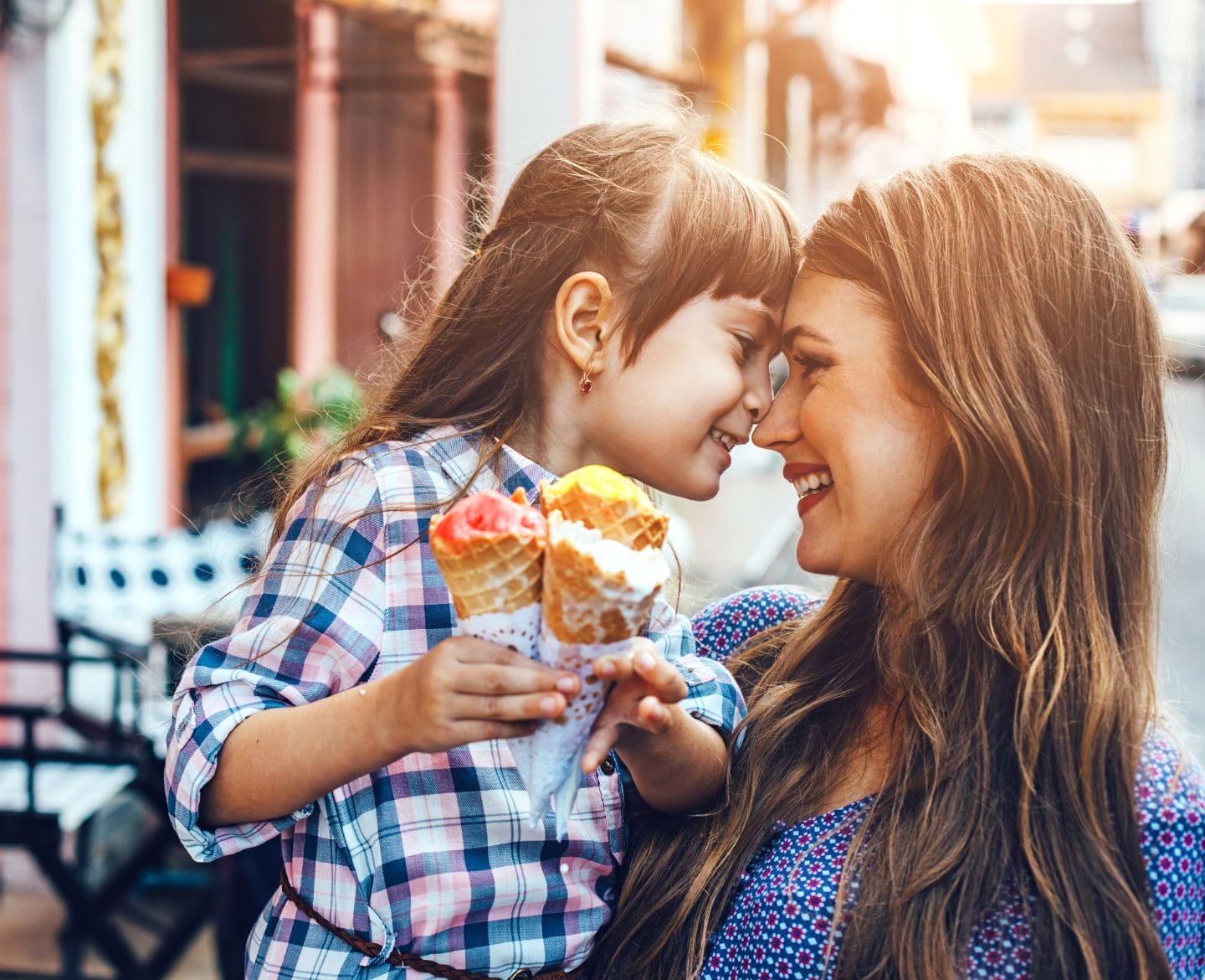 Being a mom hasn’t hurt my career—it helped mom and daughter with foreheads pressed against each other eating ice cream