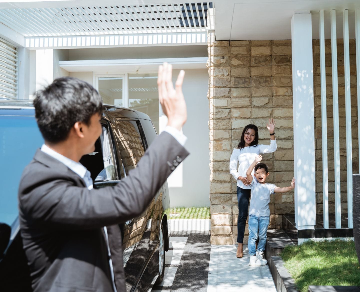 5 tips for successful co-parenting, according to an expert co-parenting mom and son waving goodbye to dad