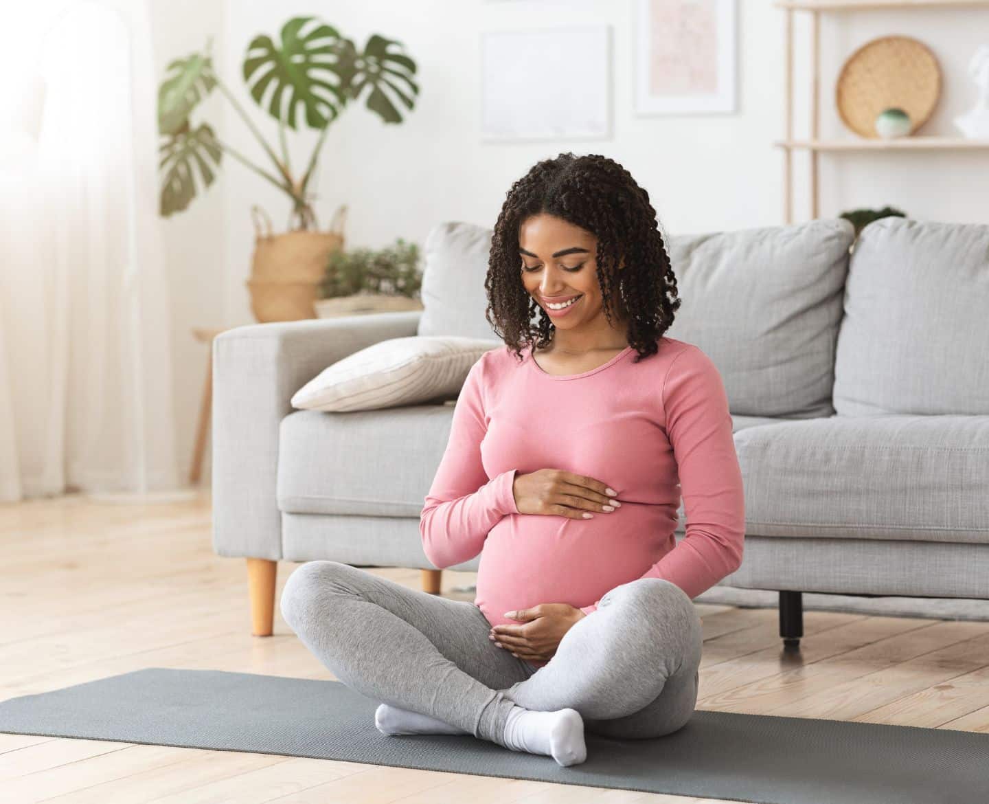 The best time to prepare for breastfeeding? Pregnancy pregnant woman sitting on living room floor on a mat