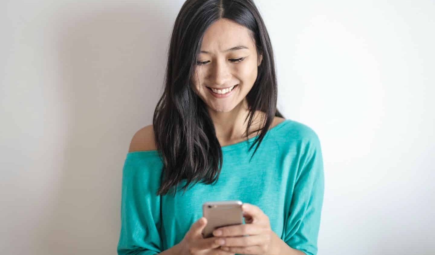 A love letter to the mom friends I always text—but rarely see woman texting on phone- mom friends