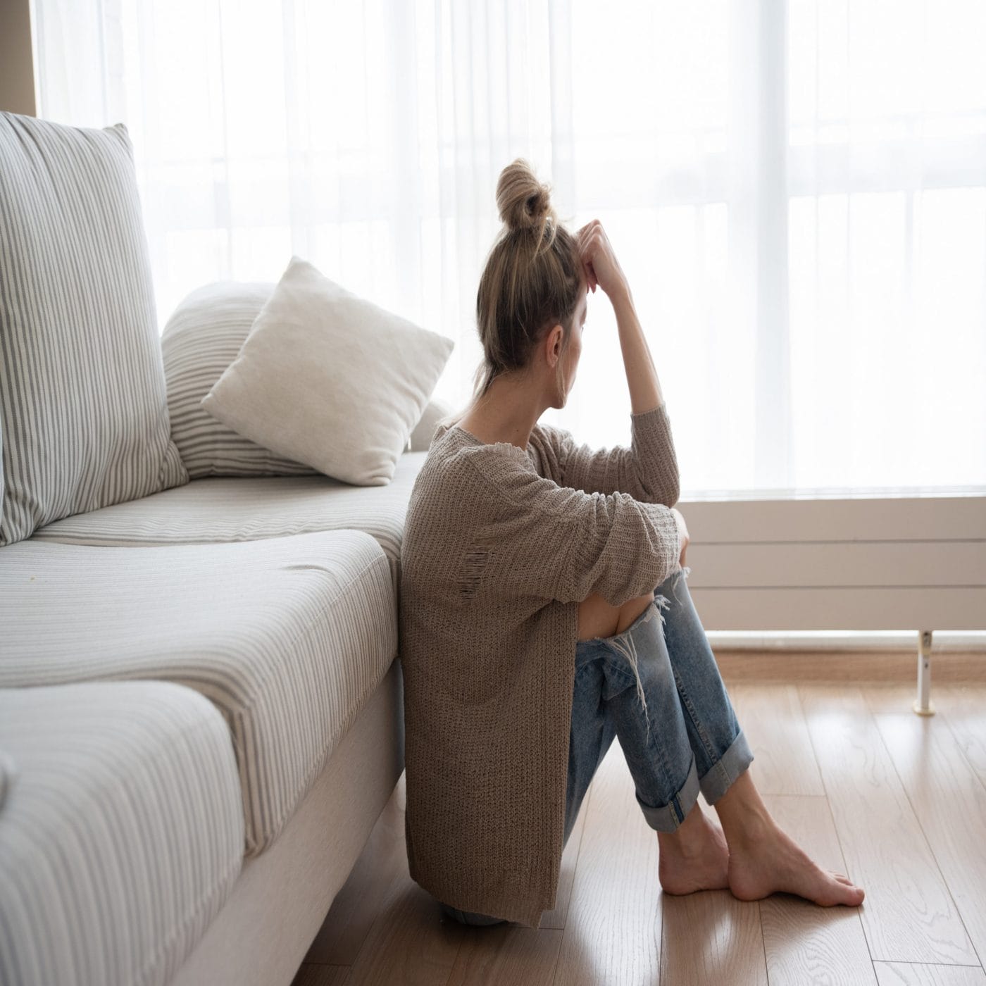 5 ways to manage the Sunday Scaries as a mom woman sitting on the living room floor