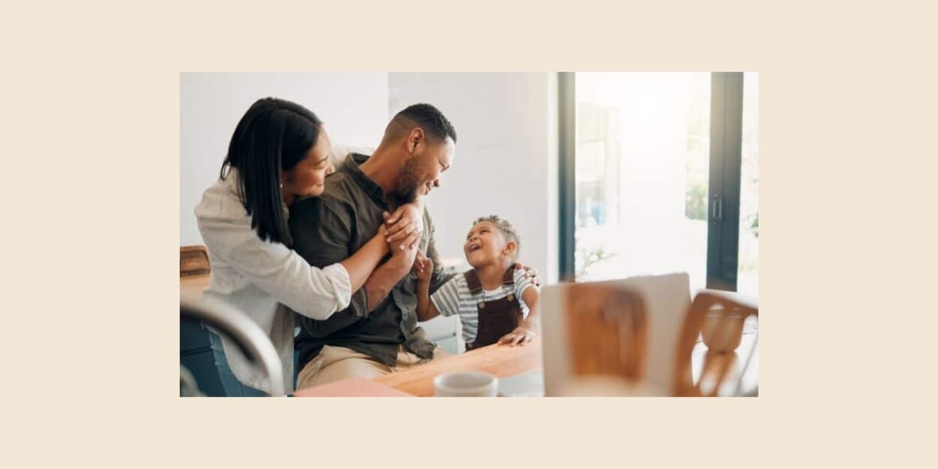 Showing a little PDA in front of your kids is more than OK—it’s healthy! PDA: A mom and dad hugging in front of their child