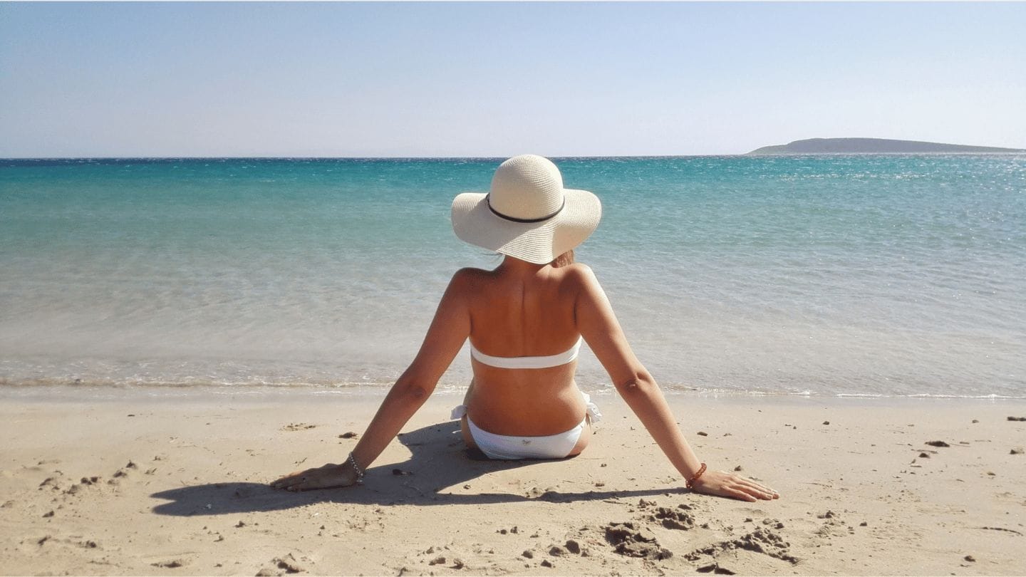Yes, after kids, vacations become trips—so take a solo mom vacation woman on beach alone