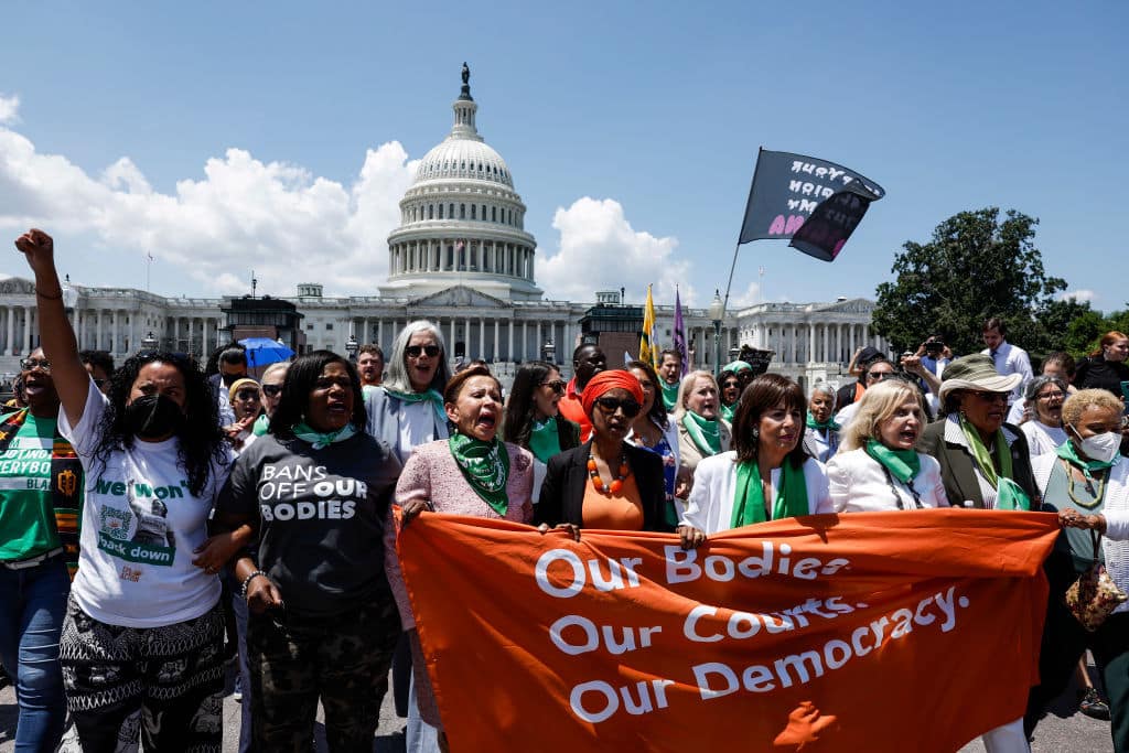 We need to talk about the Kansas landslide vote to preserve abortion rights—because it’s HUGE Women protest for abortion rights