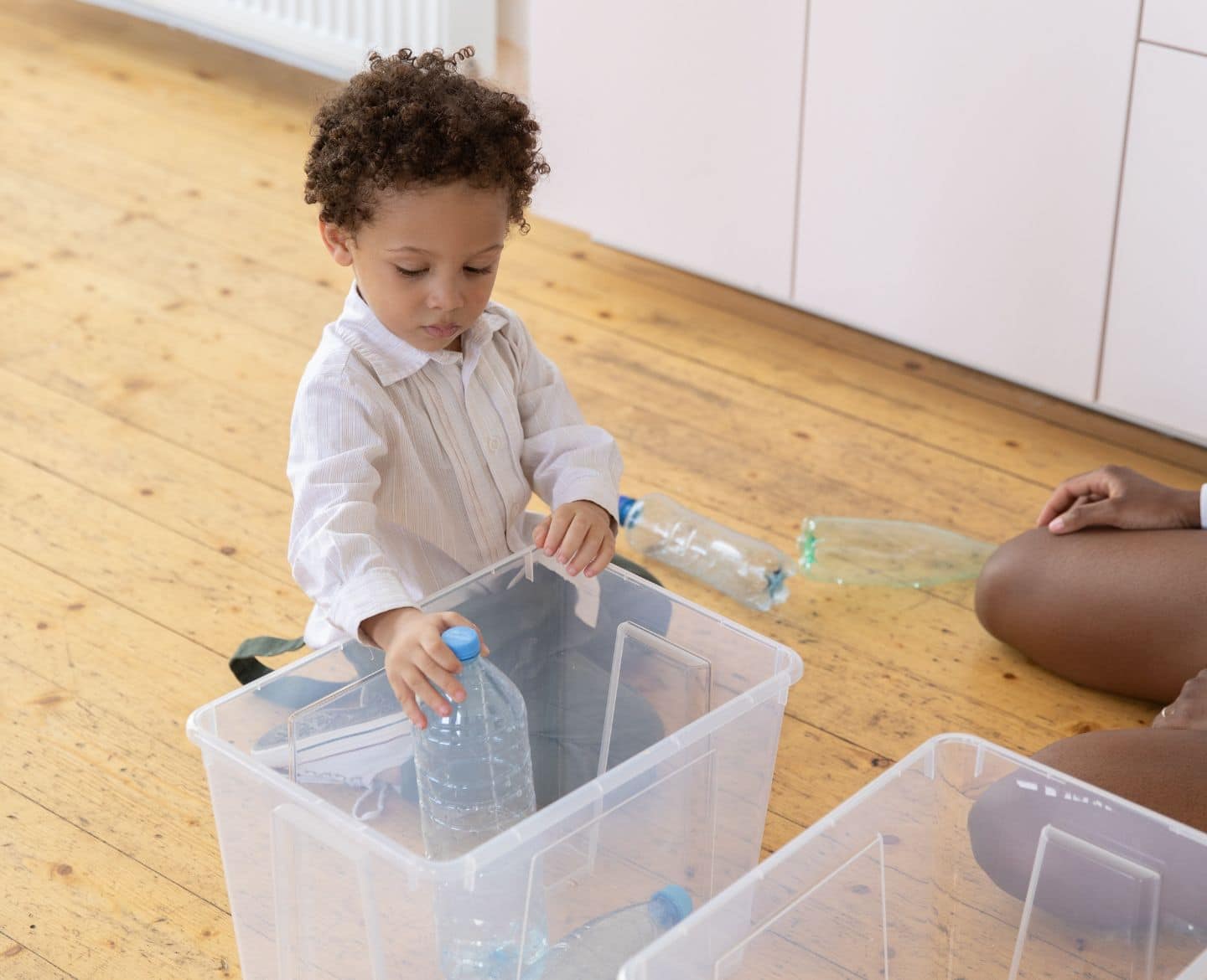 How to raise an organized kid, according to an expert child cleaning up toys - organized kid