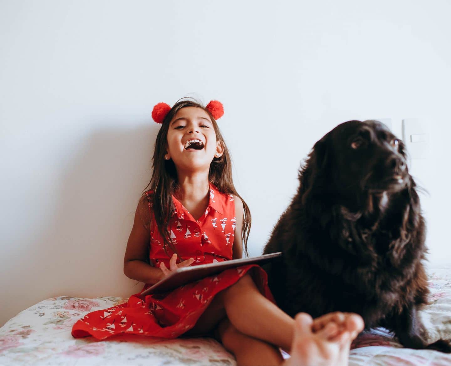 Welcoming a new pet to the family? How to pet proof when you have kids laughing girl with dog-pet proof