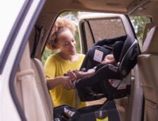 A parent’s guide to car seat safety: Tips, rules & product picks Mother putting baby in infant car seat into car - car seat safety