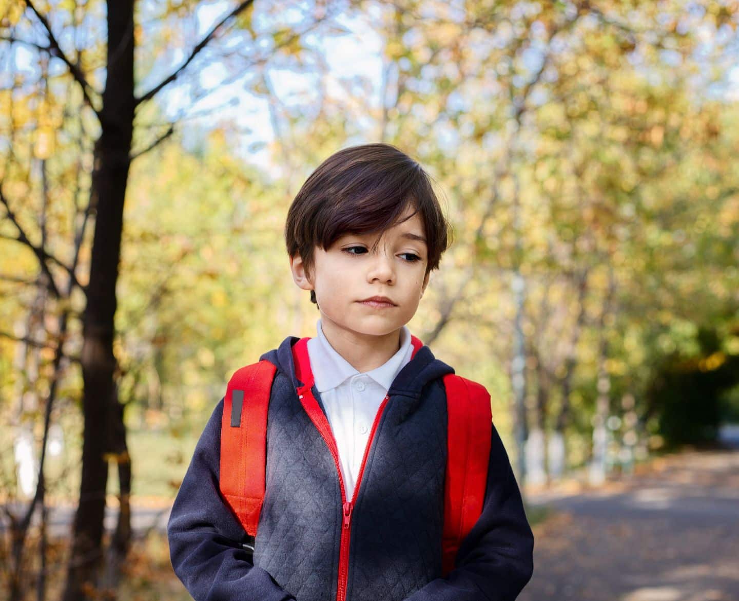 6 back-to-school mental health tips for kids, from a pediatrician sad child walking to school with backpack - student stress