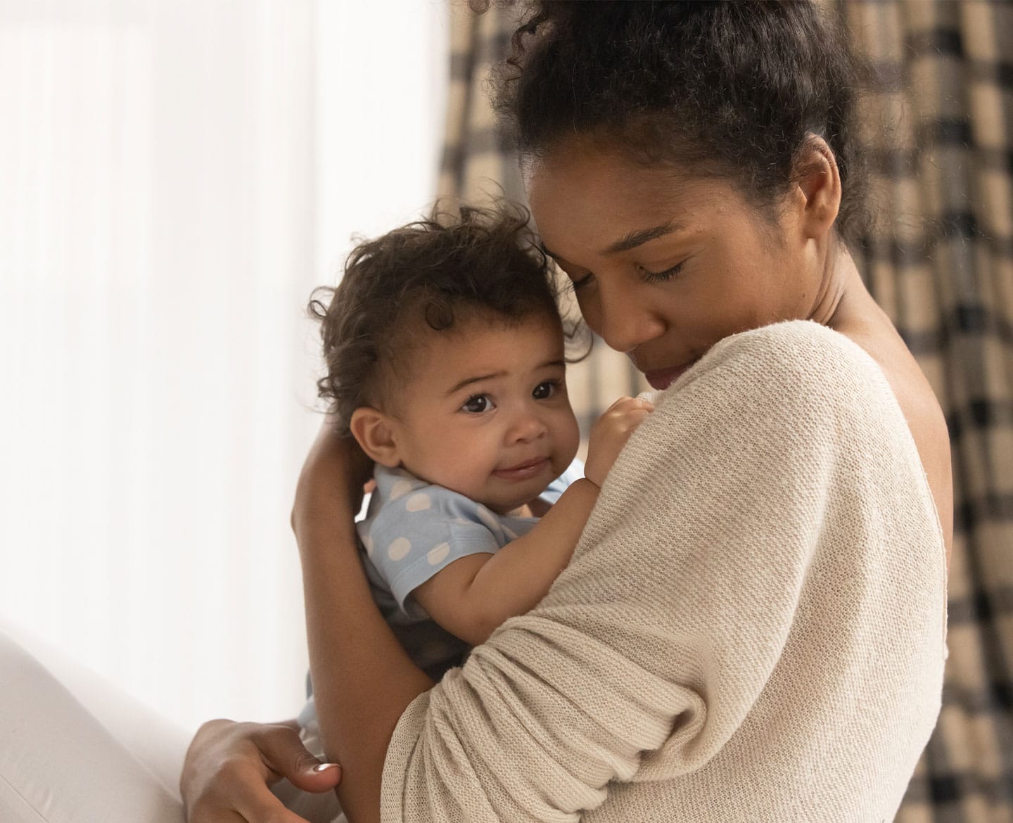 To improve moms’ health, we must focus on social determinants mom holding baby affected by social determinants