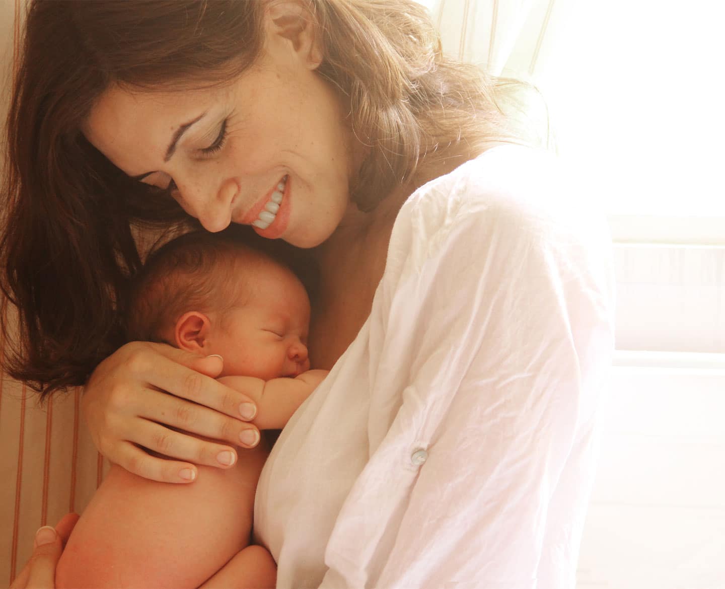 It’s time for employers to stop penalizing parents who take paid family leave mom holding newborn baby taking paid family leave