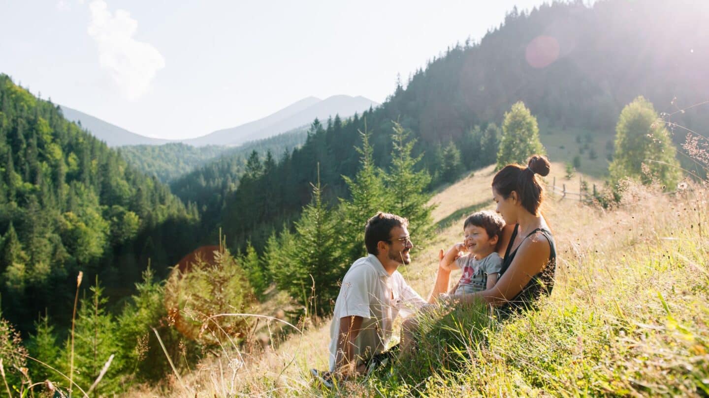 10 extraordinary rentals you won’t believe exist mother father kid sitting on hill- unique vacation rentals
