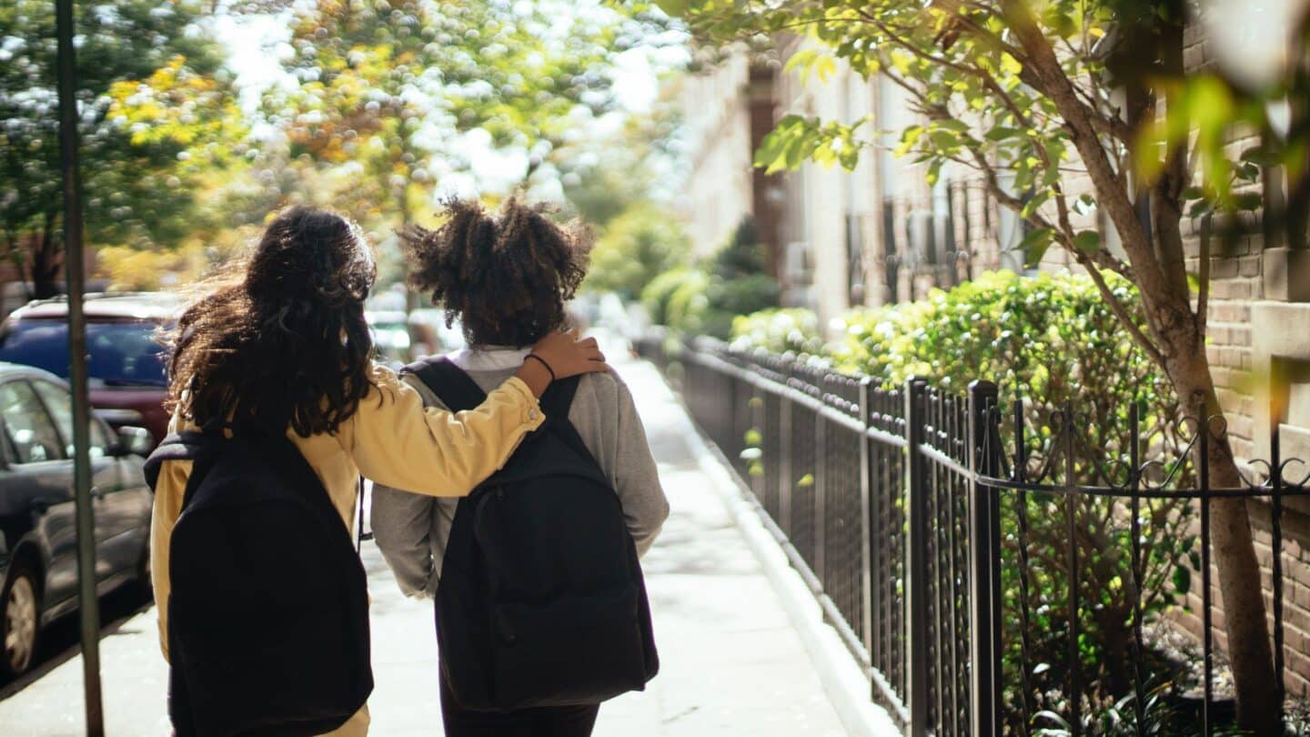 Will a bulletproof backpack insert actually help protect your child? two kids walking to school wearing backpacks - do bulletproof backpacks work